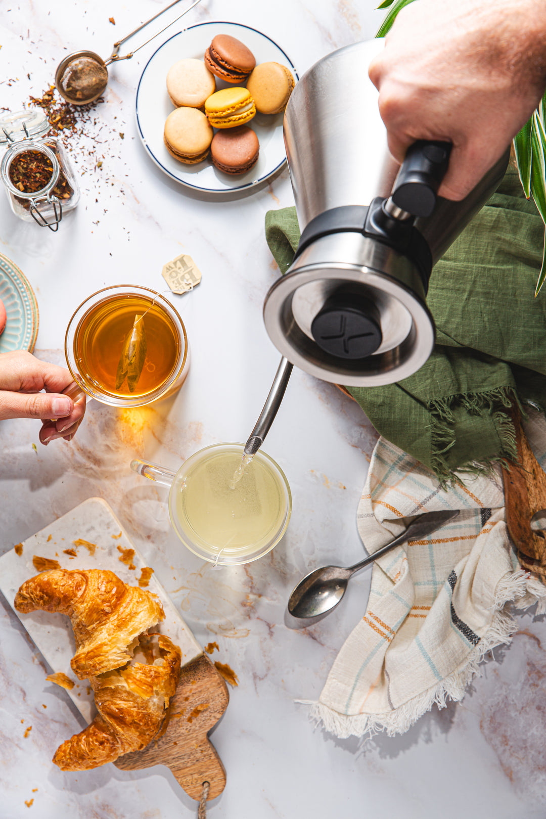 looking down on the Chettle brewing tea on a marble countertop with pastries