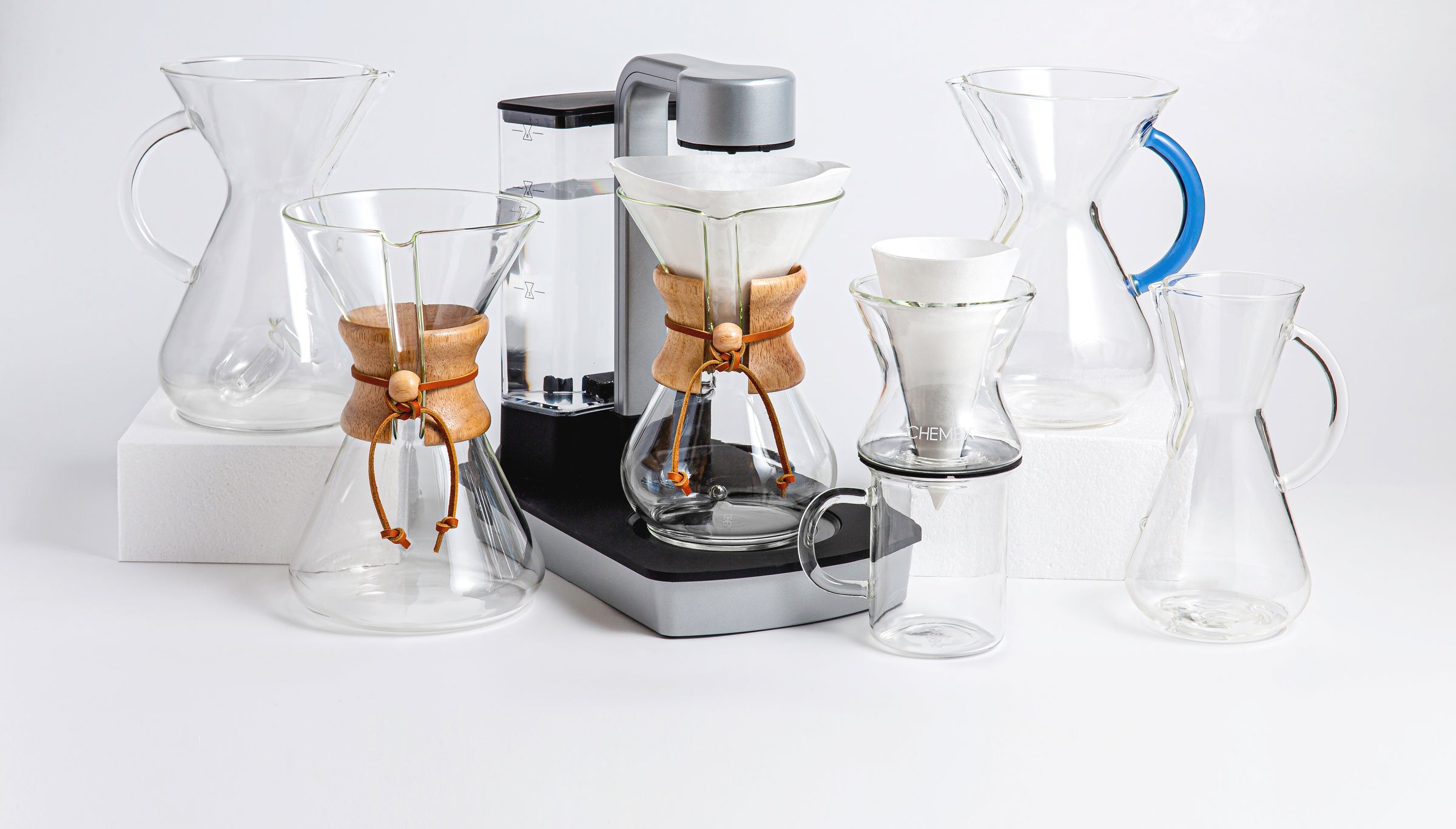 all of the chemex coffeemakers together on a light color background.