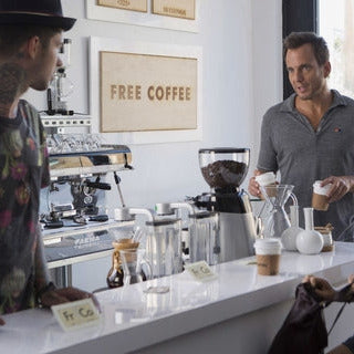 This image is from the Netflix series Flaked, featuring actors Will Arnett and Ruth Kearney in a coffee shop setting featuring many chemex products