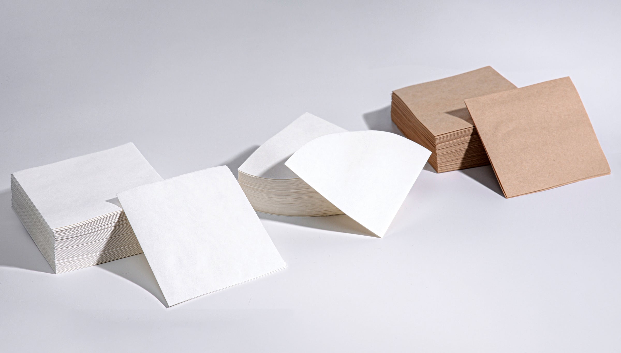 stack of white square filters next to a stack of white circle and natural square filters