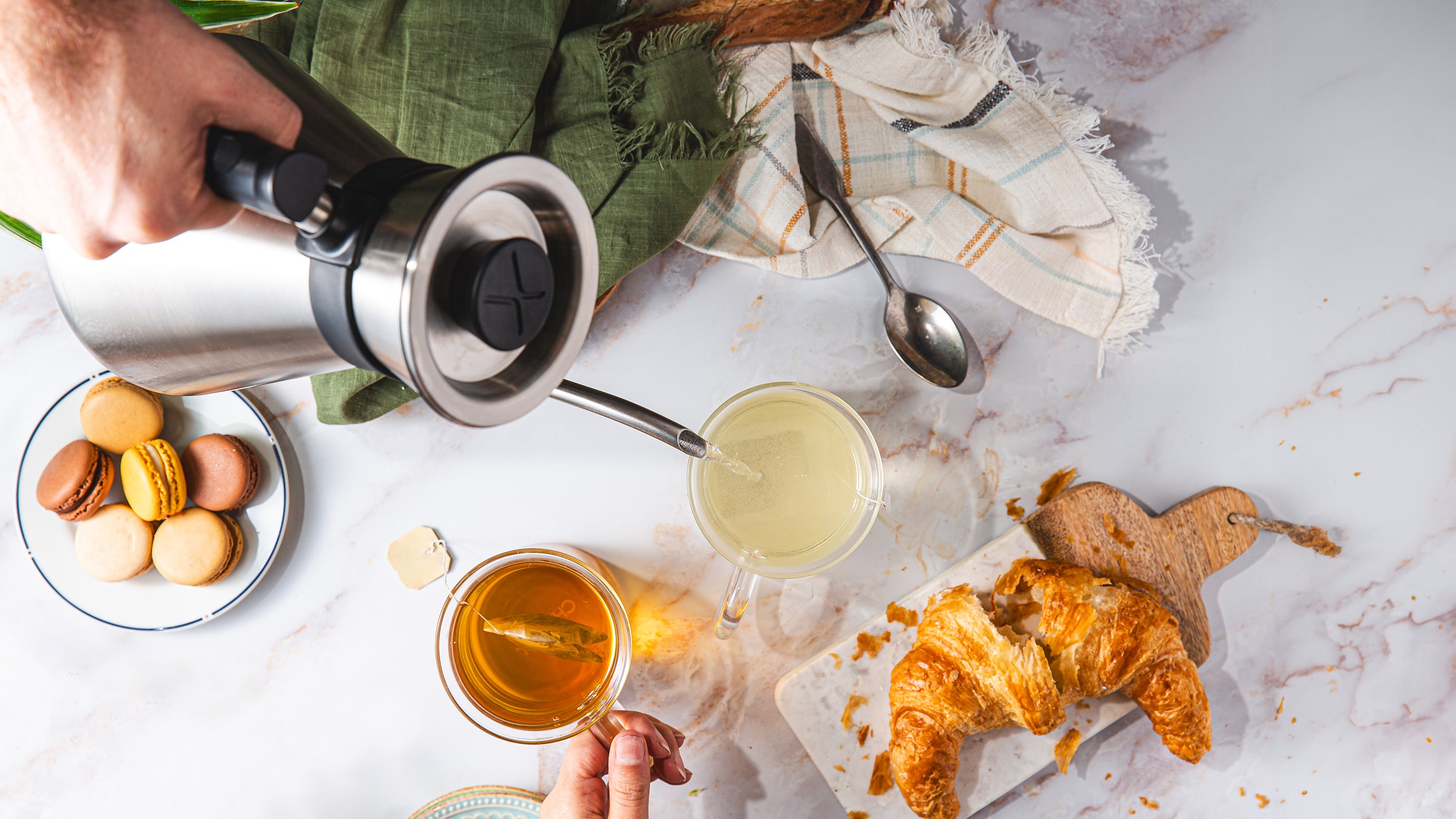 Looking down on the Chettle brewing tea on a marble countertop with pastries