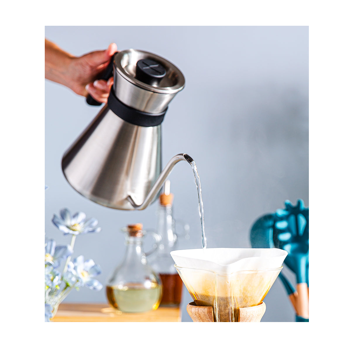 The Chettle pouring hot water into the CHEMEX filter to brew coffee.