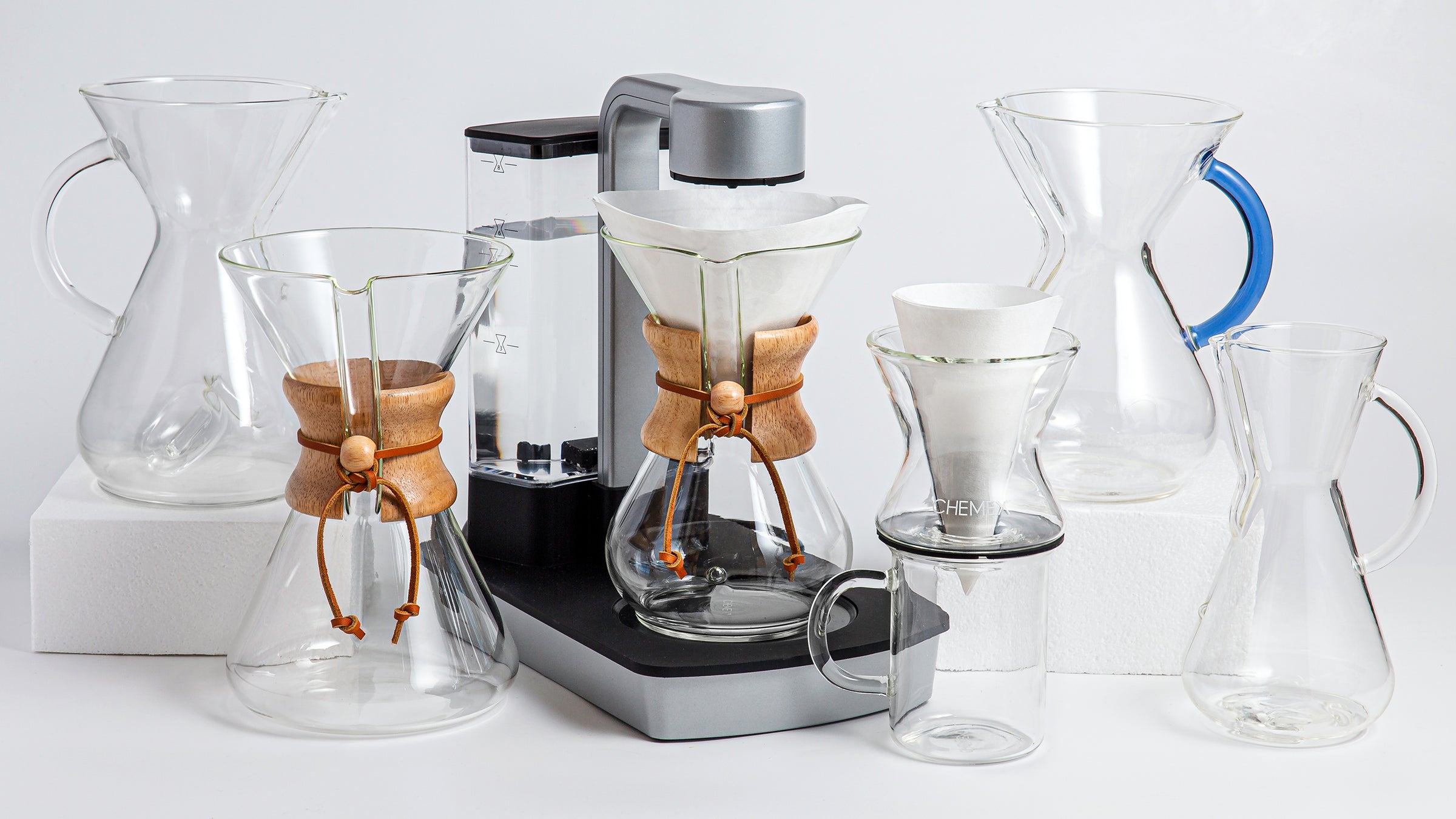 Chemaer, handblown coffeemaker, ottomatic, funnex on a murray mug, glass handle coffeemakers next to each other against a light background