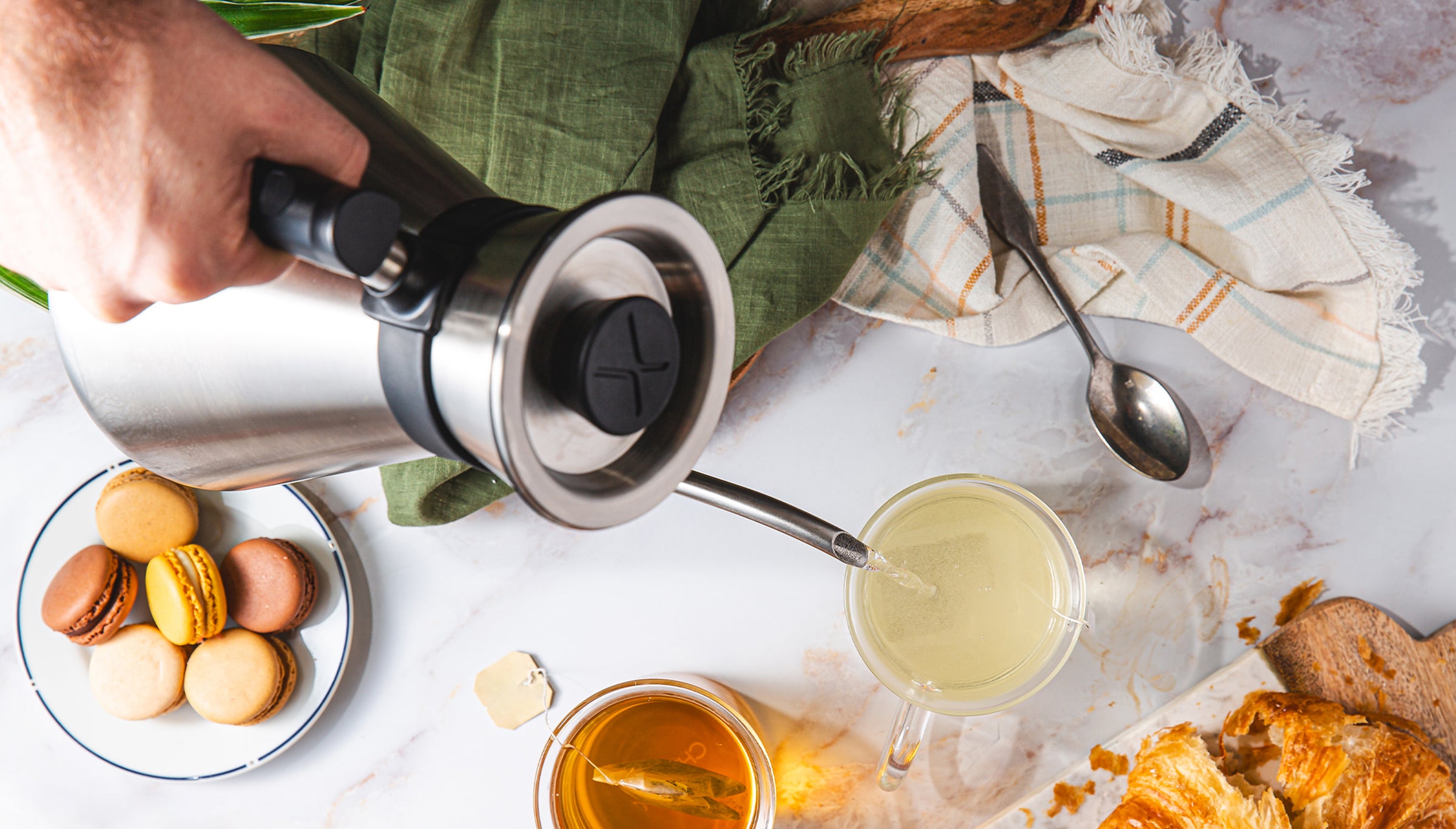 Looking down on the Chettle brewing tea on a marble countertop with pastries