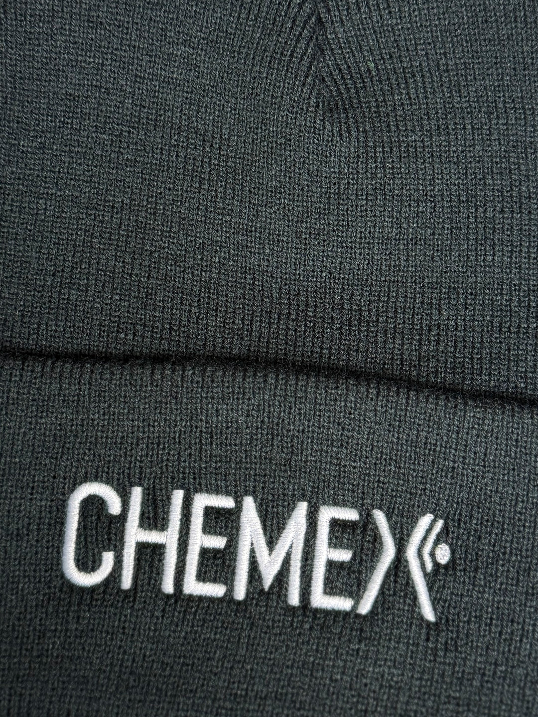 Close-up of a black beanie with &