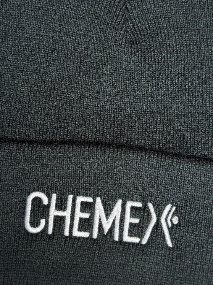 Close-up of a black beanie with &