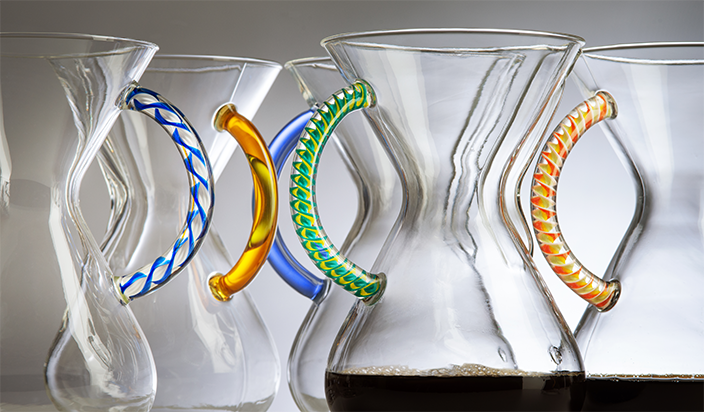CHEMEX Color Glass Handle close-up — blue, gold, green twist, and orange spiral handles on clear glass coffeemakers, 2023